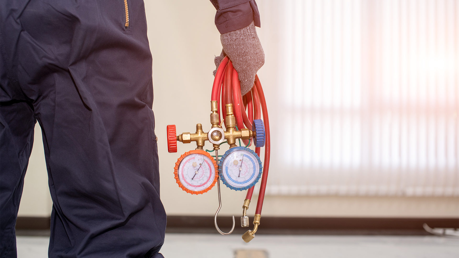electrician from the back holding tool close up