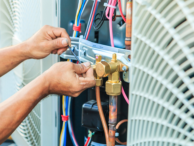 hvac technician hands close up installing air conditioner collinsville il