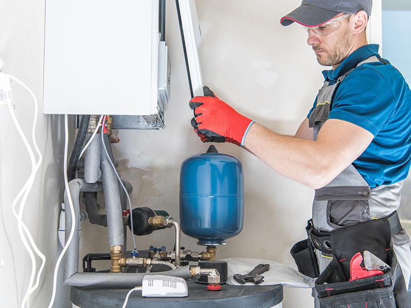 hvac technician installing gas furnace at house interiors collinsville il