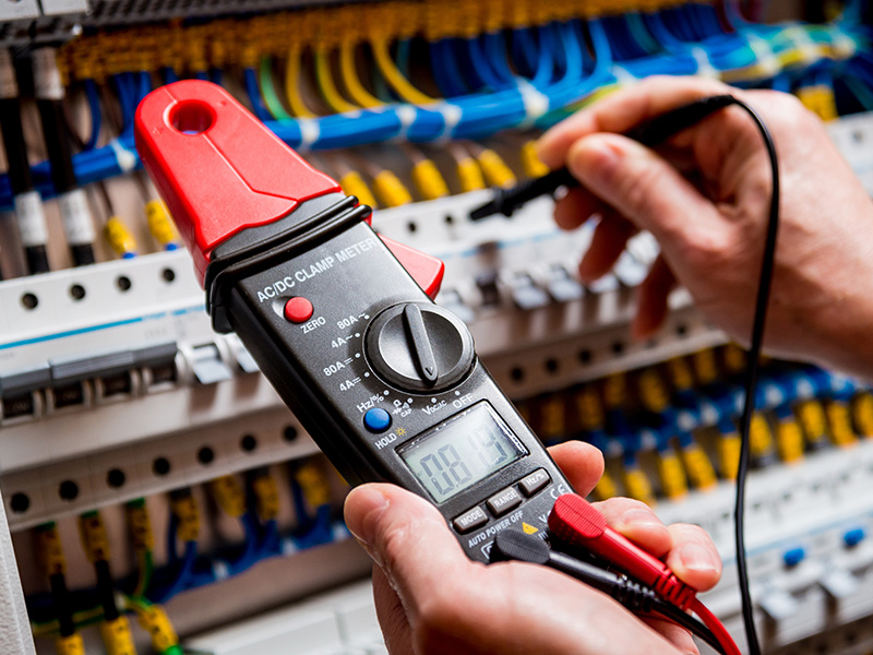 technician hands close up with tools upgrading commercial building circuits panel collinsville il